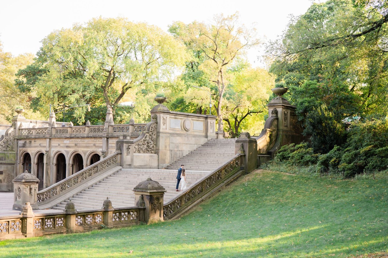 Stone staircase and architectural features in a historic garden setting during golden hour.