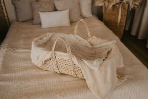 A collection of natural linen and cotton fabrics with macrame details arranged in a neutral beige color palette.