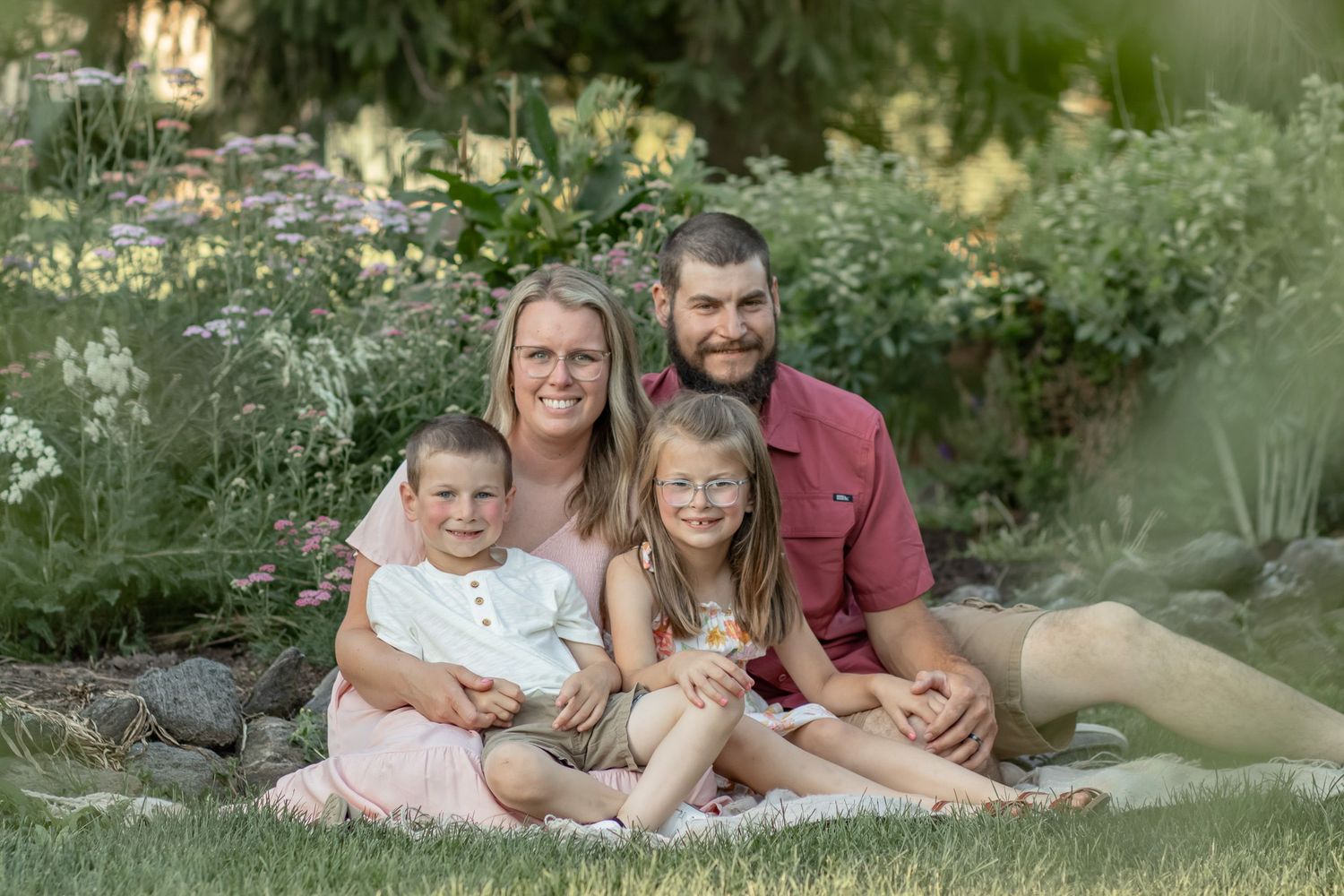 Family posing for a photo and smiling.