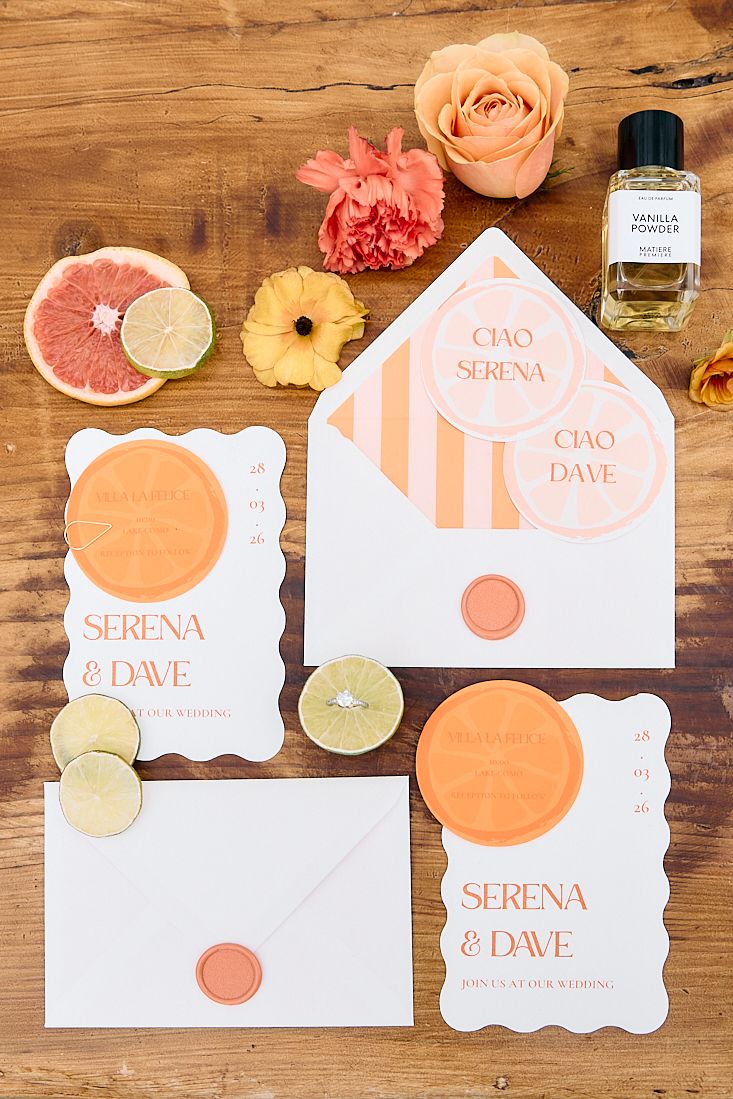 Citrus-themed wedding stationery suite for Serena and Dave with orange wax seals and tropical flowers.