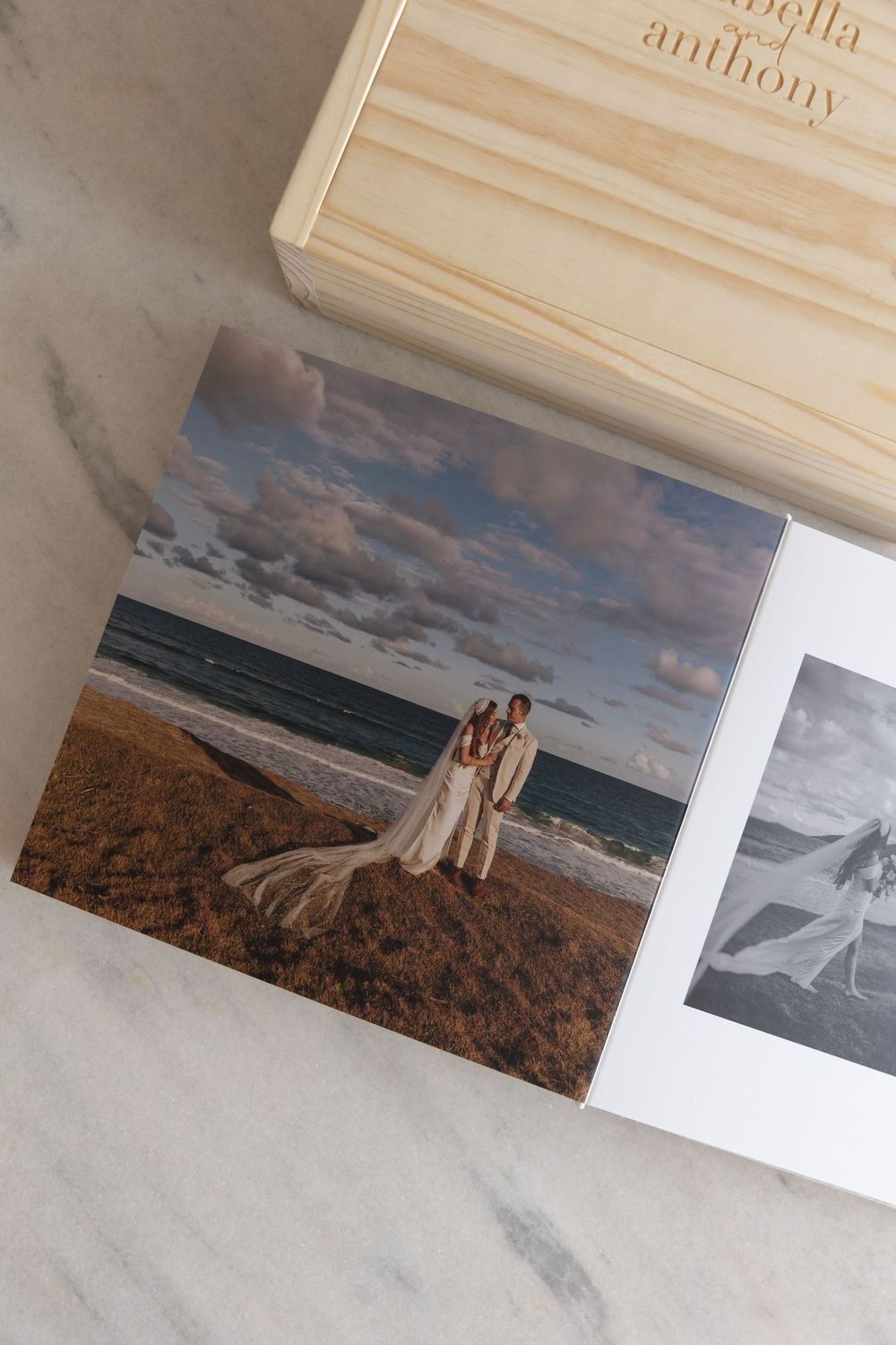 Wedding couple posing on a beach at sunset, displayed in a printed photo with a personalized wooden keepsake box.