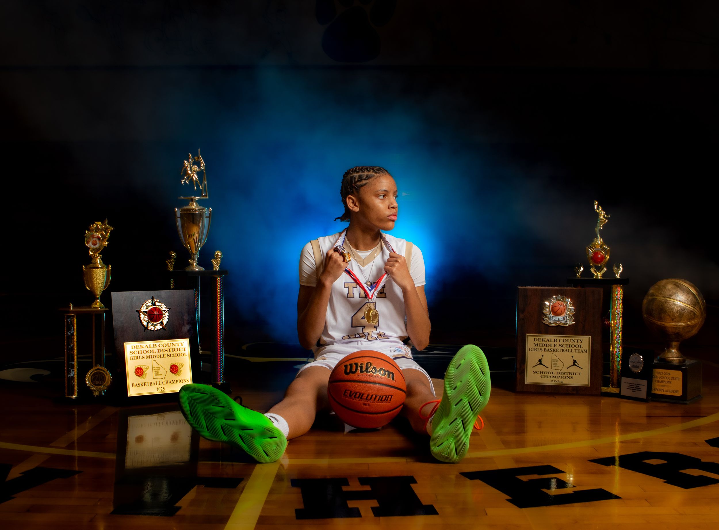 A cinematic sequence shows a person sitting at a desk with retro radios, a basketball, and neon green details.
