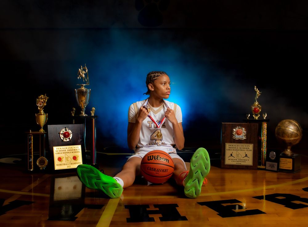 A cinematic sequence shows a person sitting at a desk with retro radios, a basketball, and neon green details.