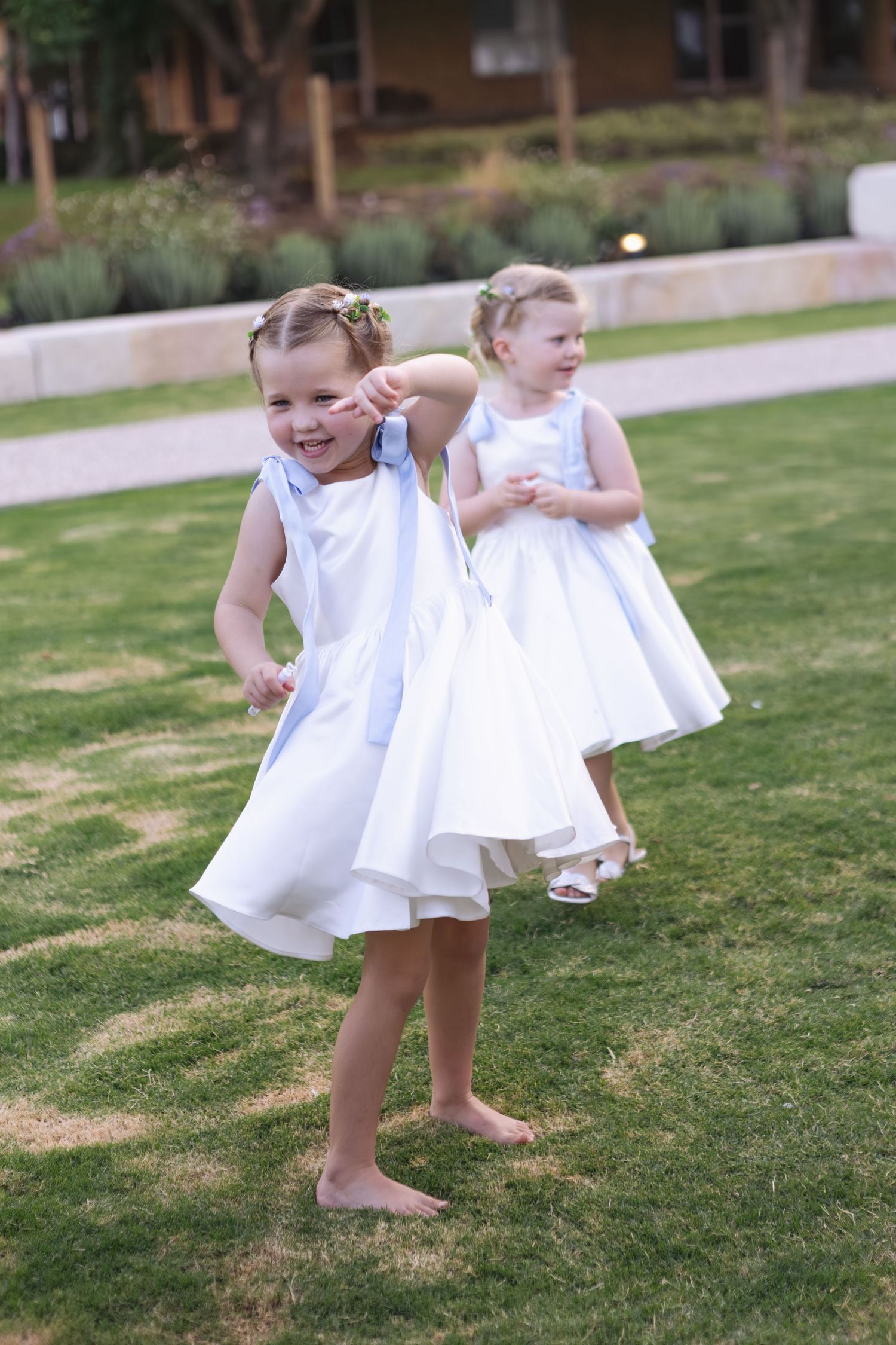 flower girls dancing on the lawn at Two Rivers Winery Wedding in Denman