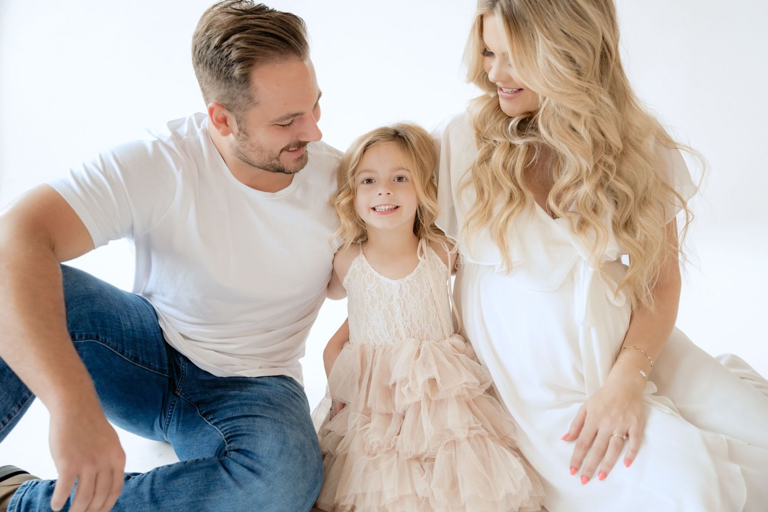 parents adoringly look at their daughter during in studio maternity session in stillwater MN with Jagger Rose Photography