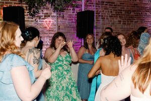 Women dancing and celebrating at a lesbian wedding reception. LGBTQ+ Wedding Photographer, Booth Creative Co. Wilmington, NC Weddings