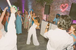 Bride dancing joyfully with guests at a wedding reception in Wilmington NC. Wilmington NC Wedding Photographer - Booth Creative Co. LGBTQ