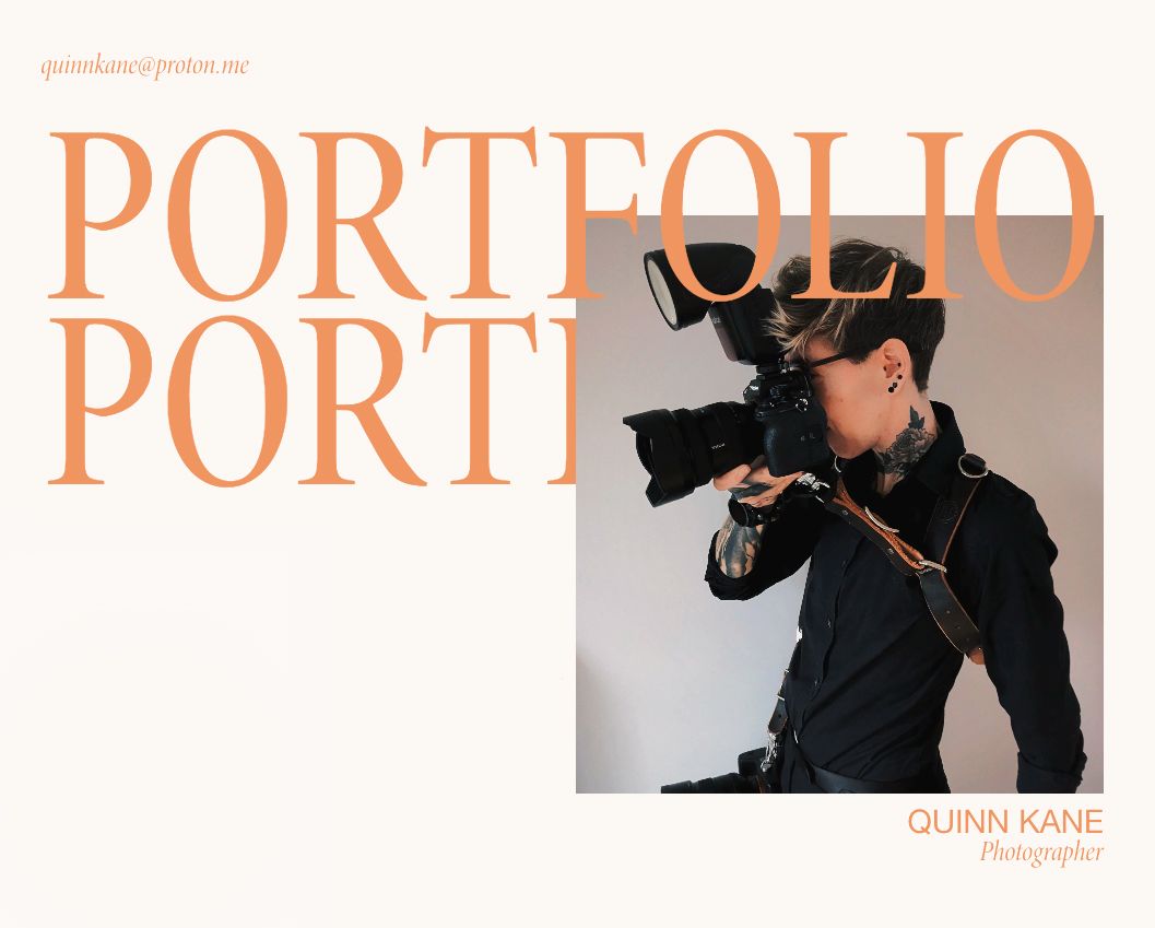 Double award winning photographer Quinn Kane holding a professional camera, wearing a black shirt and a leather harness