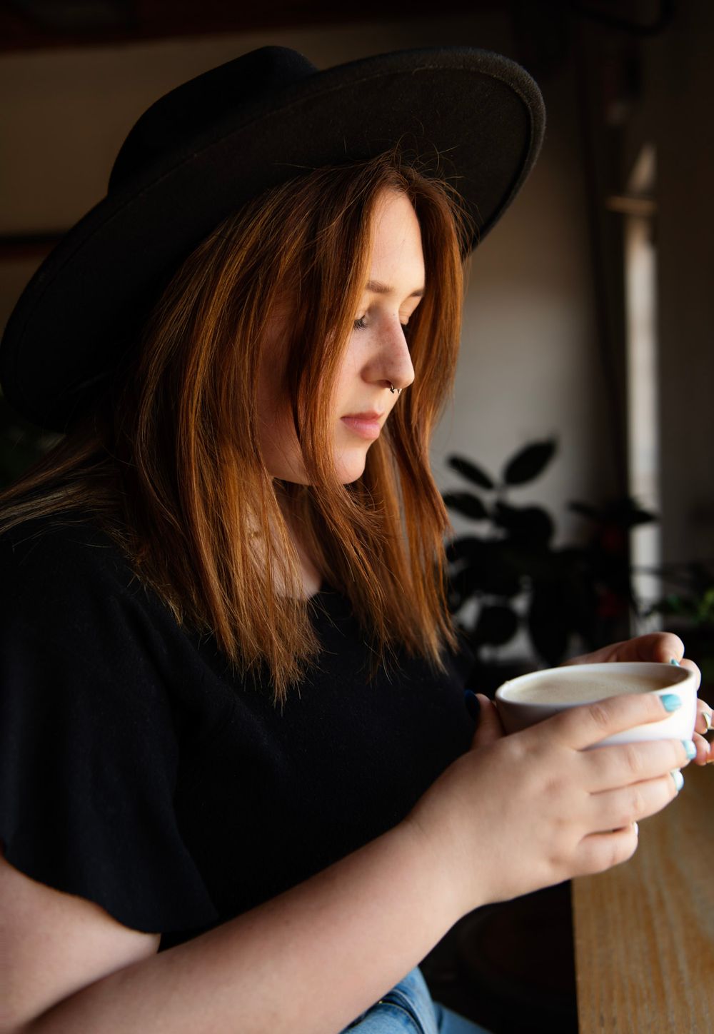 Senior girl wearing a black hat and casual outfit during a lifestyle senior session in downtown St. Pete.