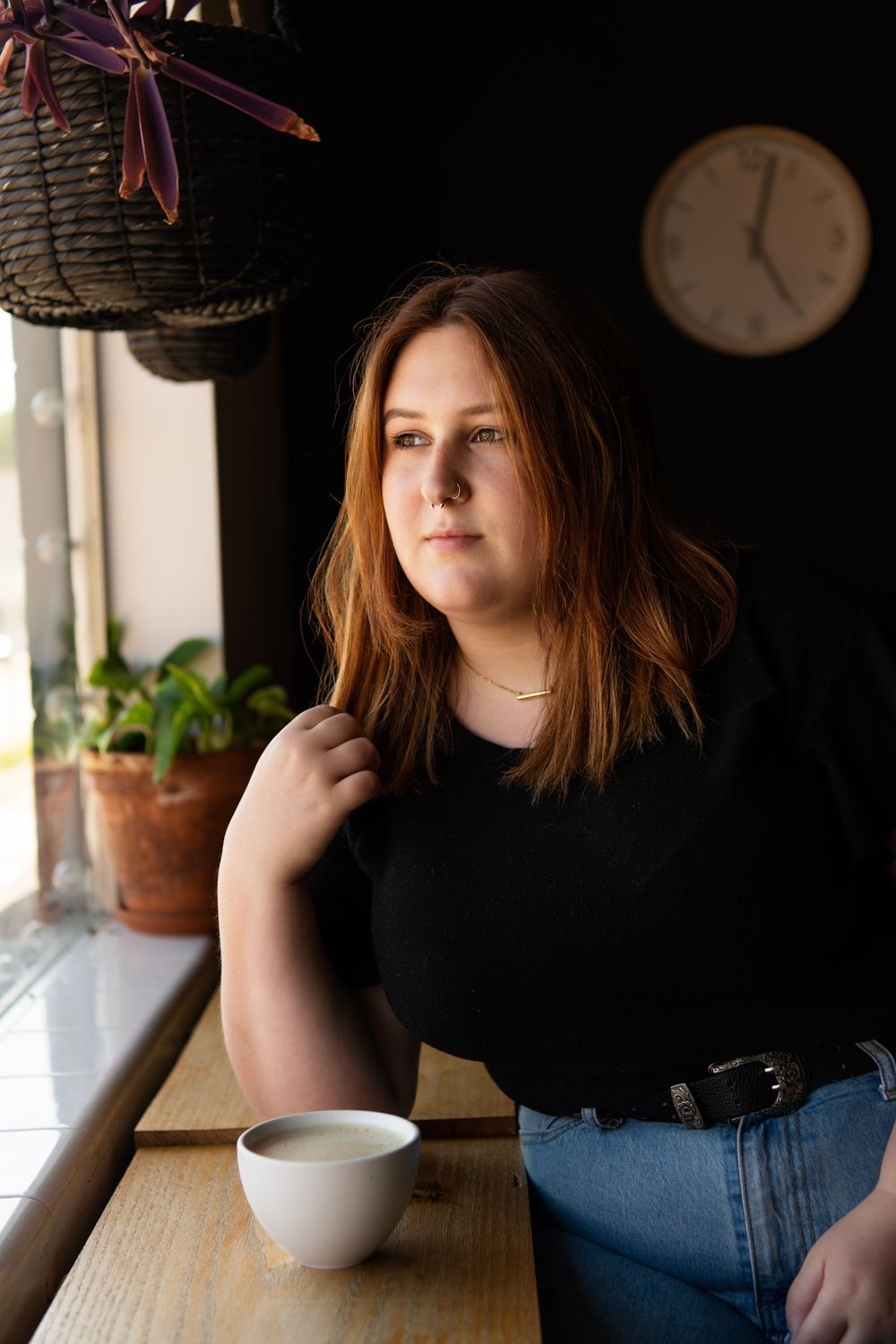 Natural light senior portrait of a high school graduate seated at a local coffee shop in St. Petersburg FL.