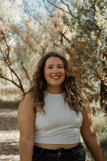Outdoor autumn portrait with natural lighting and fall foliage background.