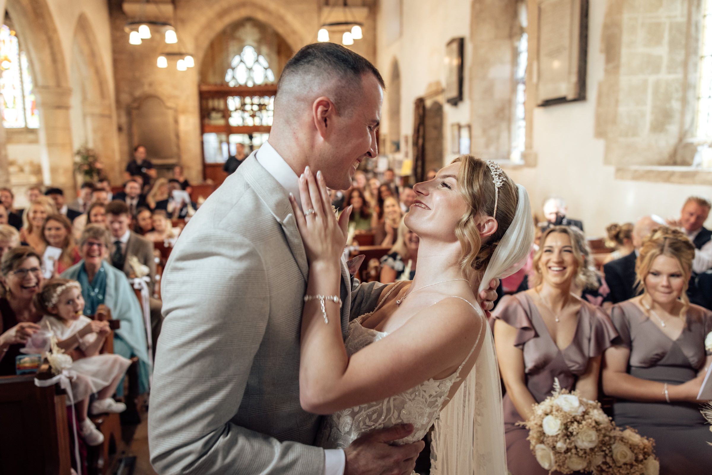hauna and Mark sharing an emotional moment during their Gloucestershire church wedding