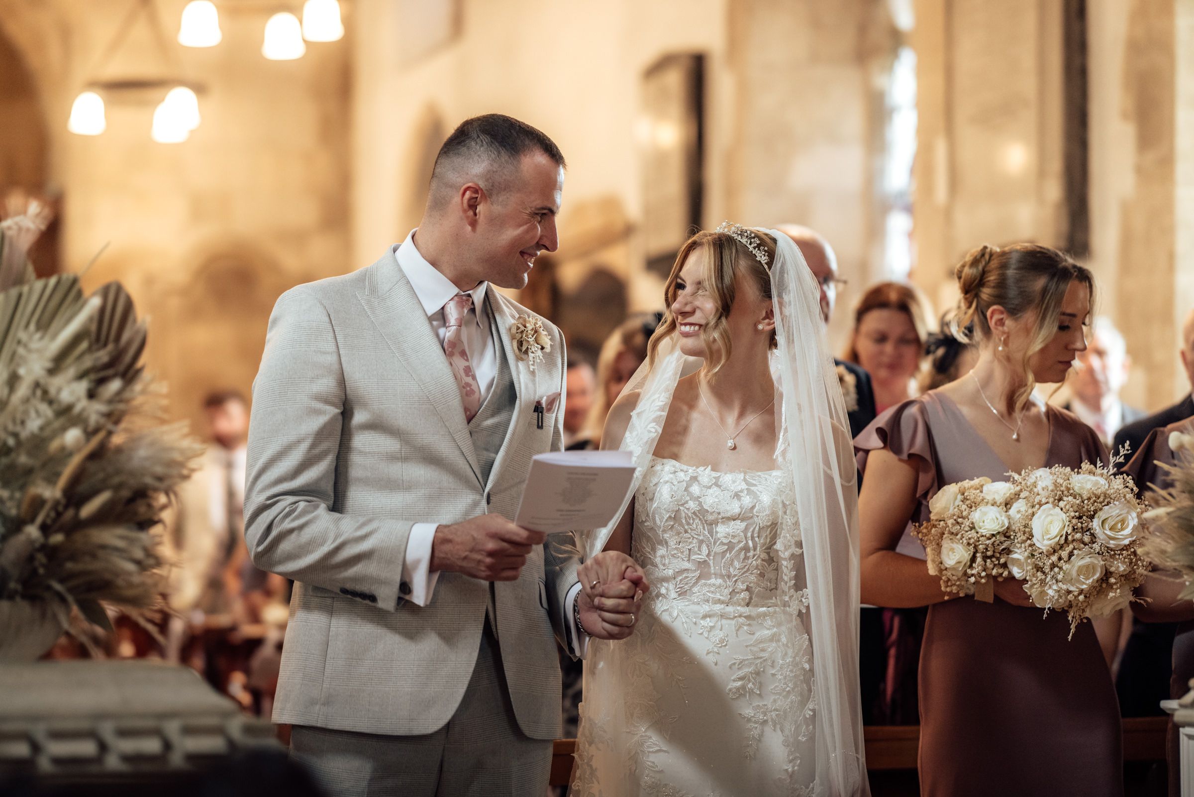 Shauna and Mark smiling together during their church wedding ceremony in Eastington