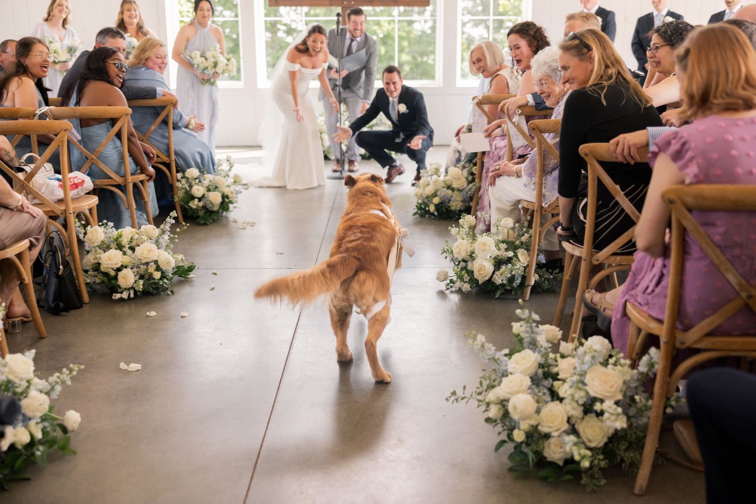 Indoor wedding ceremony with floor-to-ceiling windows and cross-back chairs at Magnolia Hill Farm, Ohio