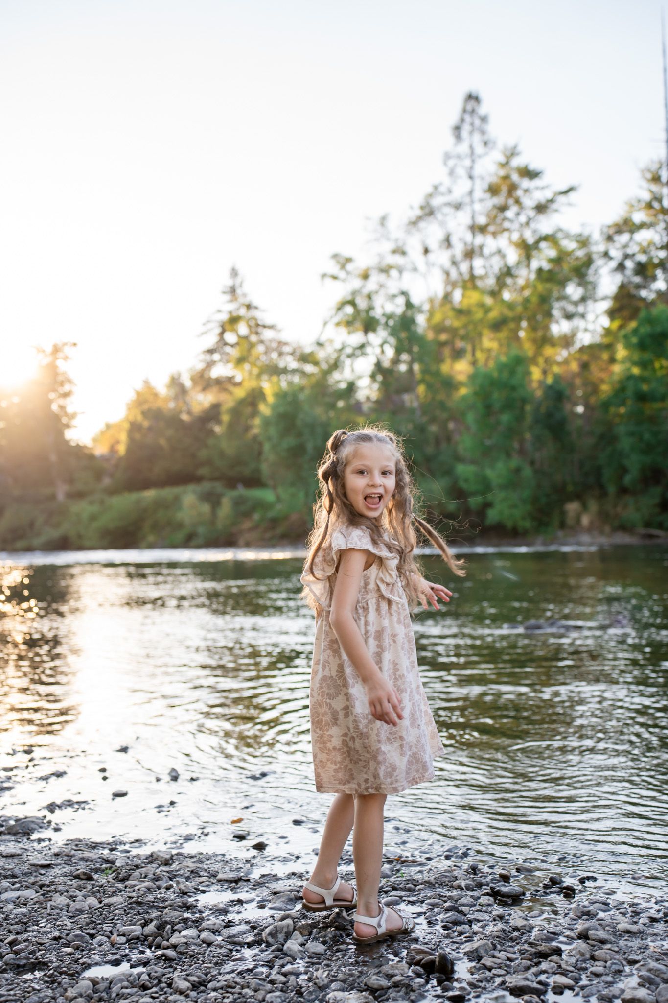 portrait of a young girl playing by the river