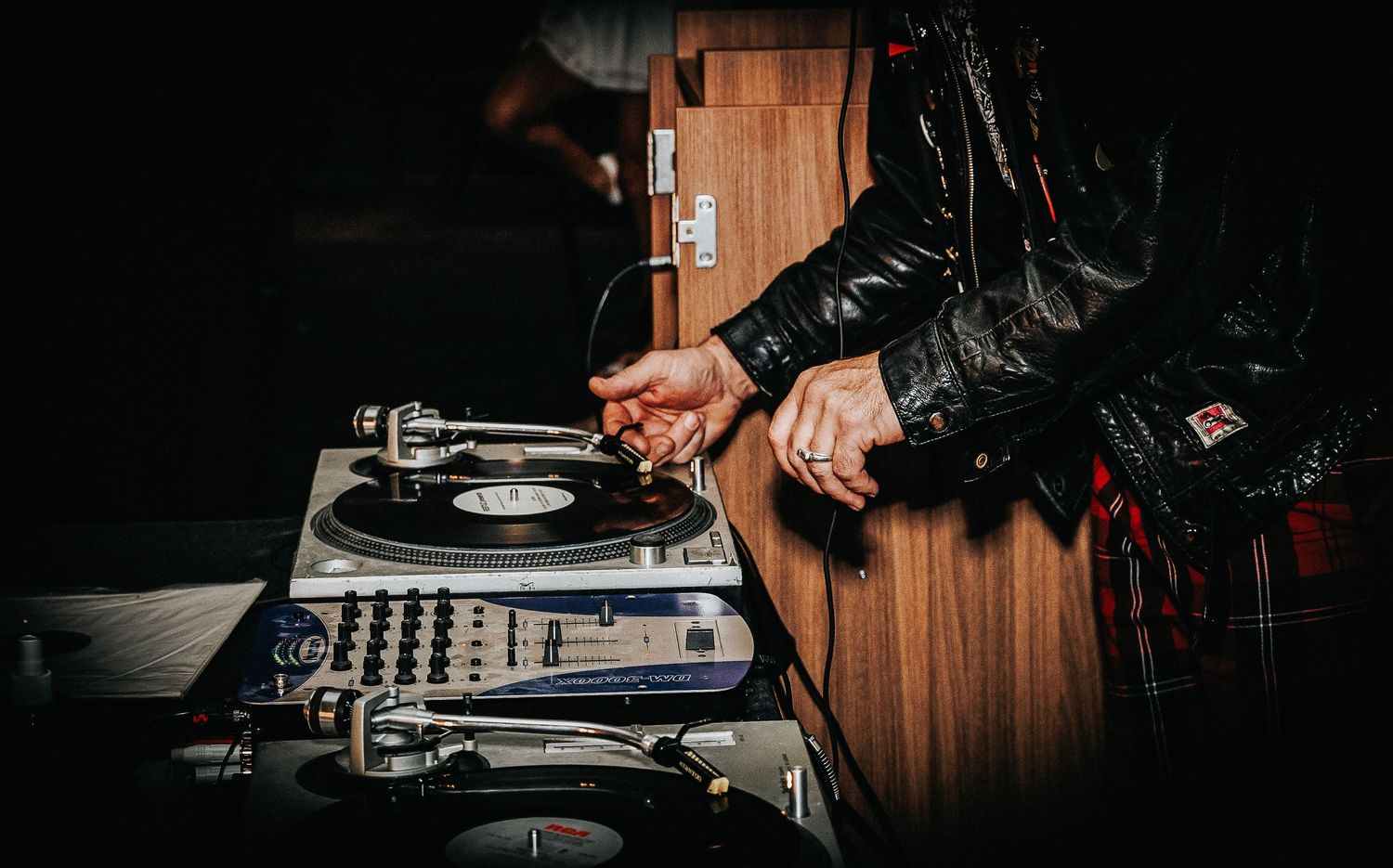 Event photography of a DJ playing vinyl records at a live event