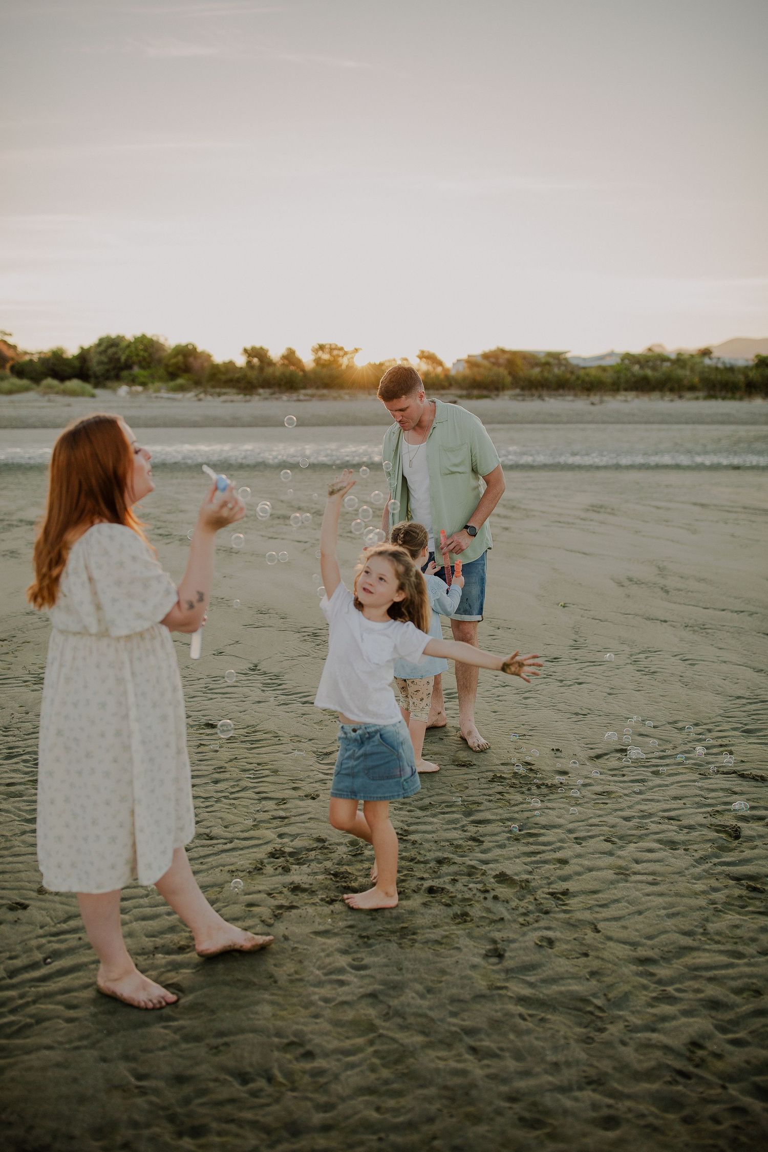 Family on beach on sunset, Family photo session with bubbles and play.