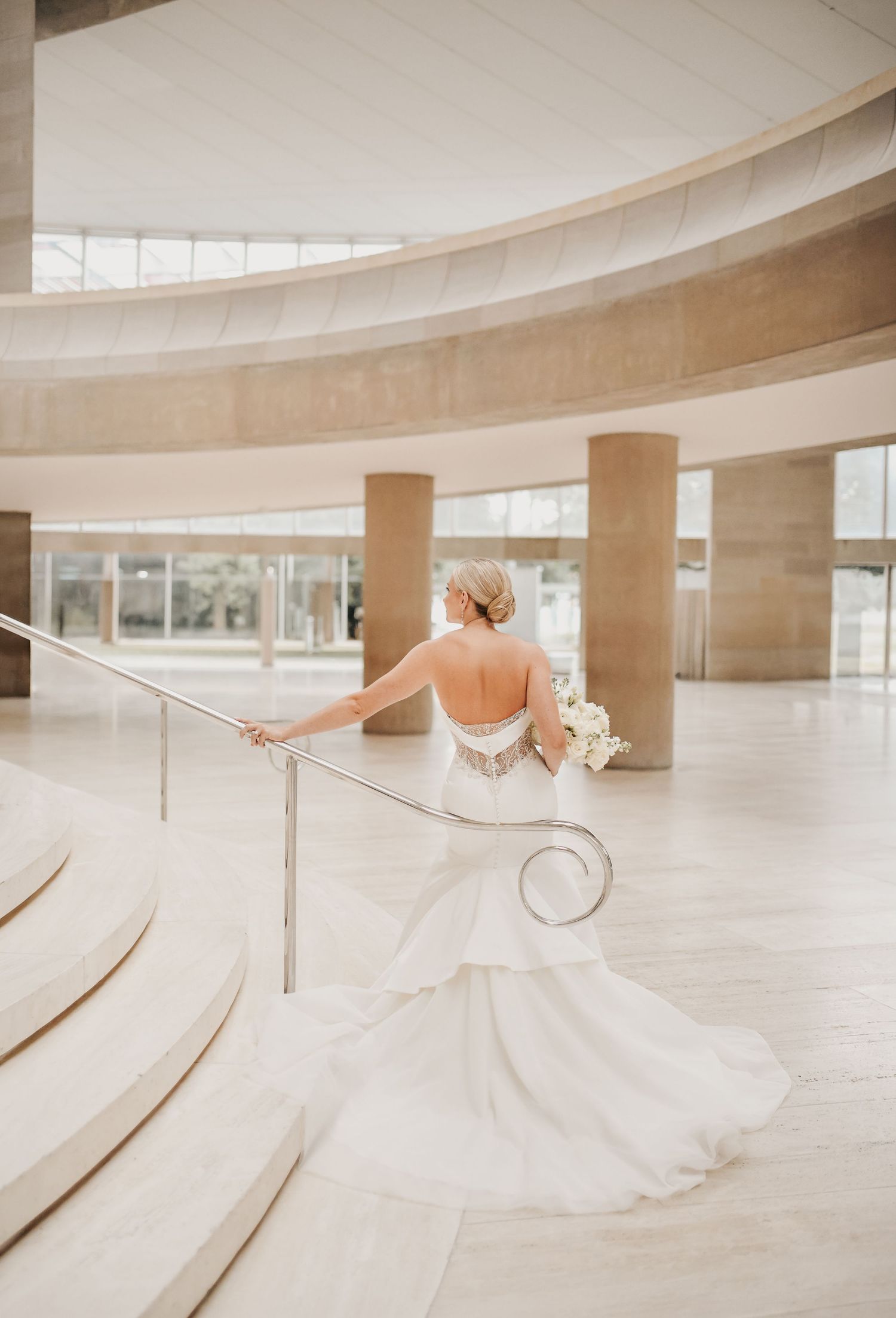 Romantic bridal portrait featuring a cathedral veil and sweeping Meyerson staircase