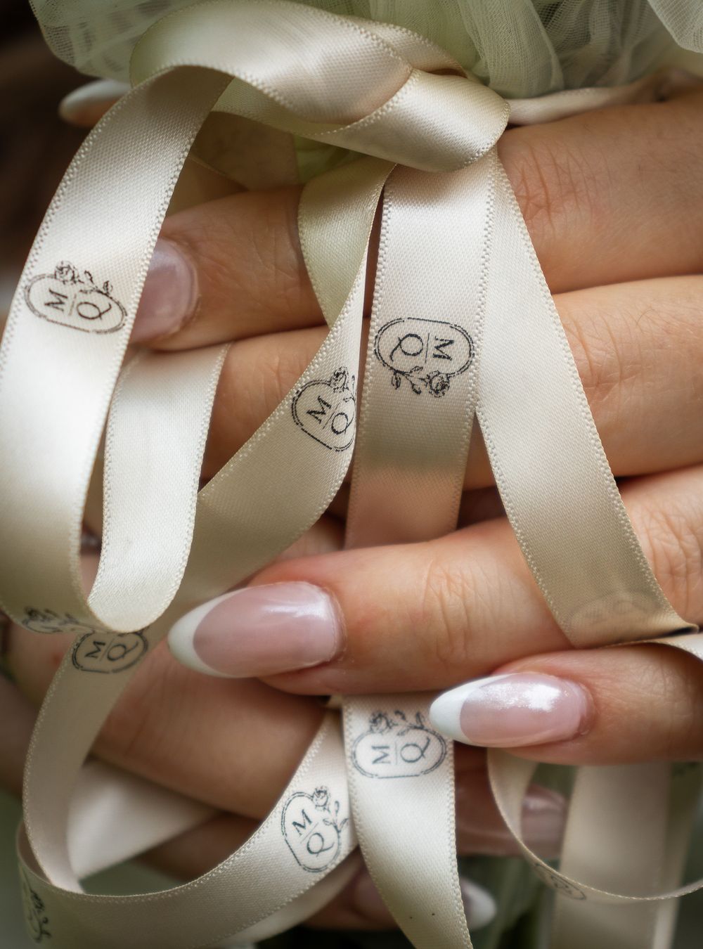 Fingers wrapped through branded ribbon in Strongsville