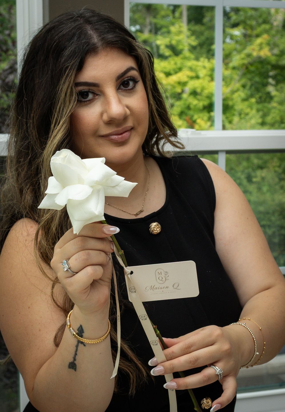 Headshot of a woman holding a flower in Strongsville.
