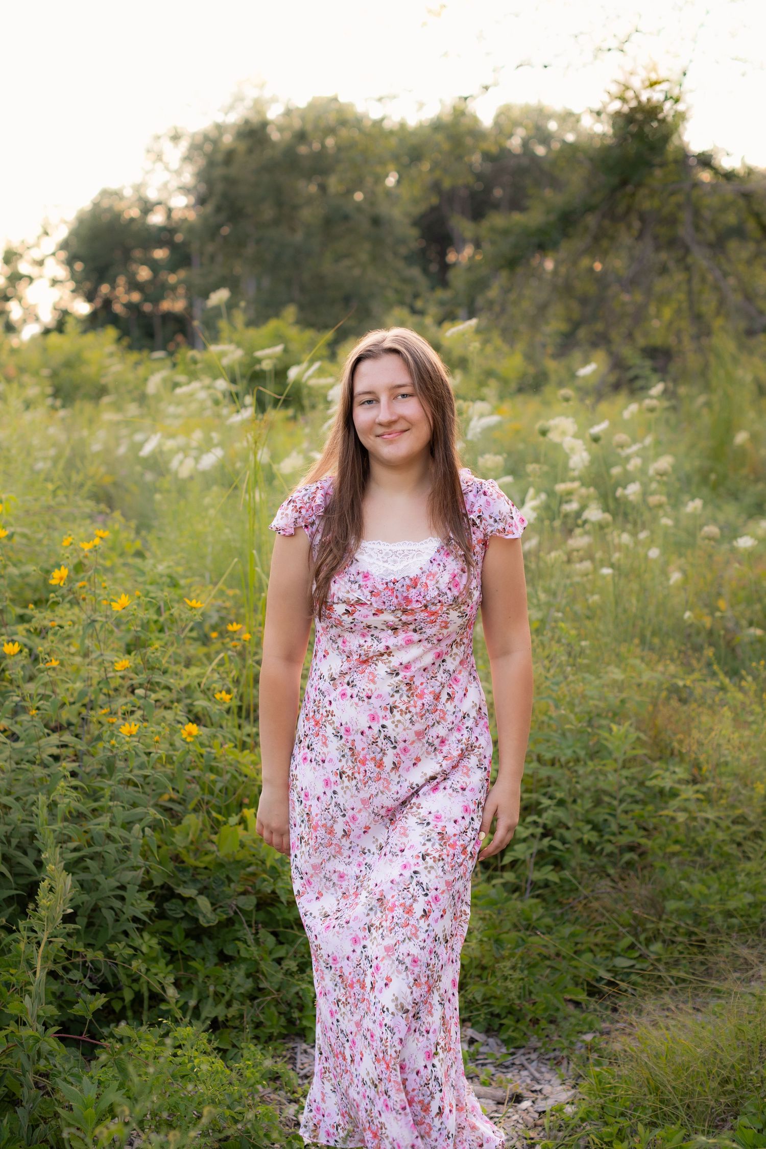 Senior girl outdoor pictures in flower field wearing floral dress in Brighton, Michigan by South Lyon, MI portrait photographer