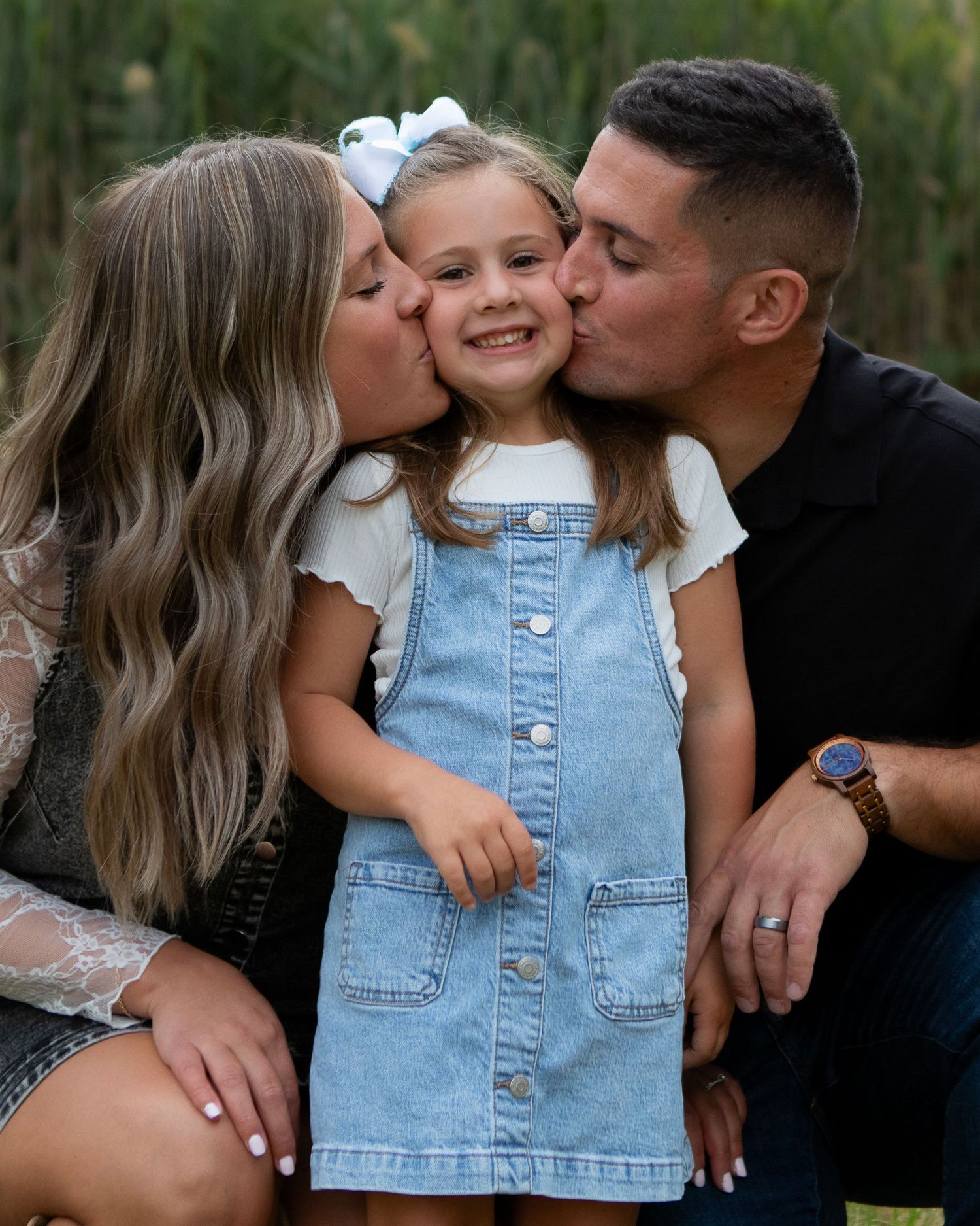 Daugher runs to mom and dad laughing by family photographer, Taylor LeAnn Photography.