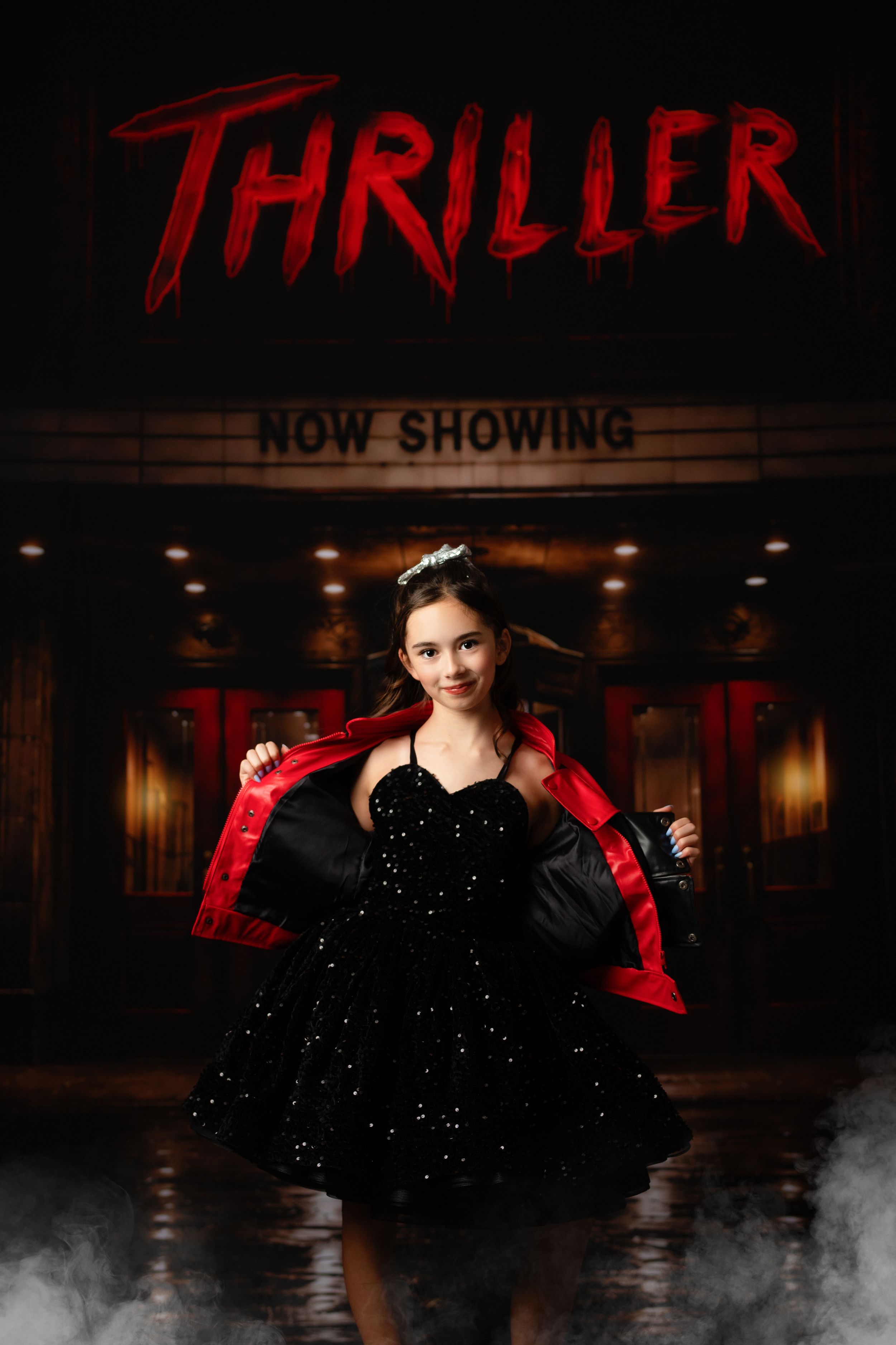 Young girl poses in black sparkle dress with red-lined jacket before a Thriller movie theater marquee.