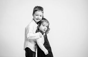 A black and white photo series showing intimate moments of a couple posing together in romantic embraces.