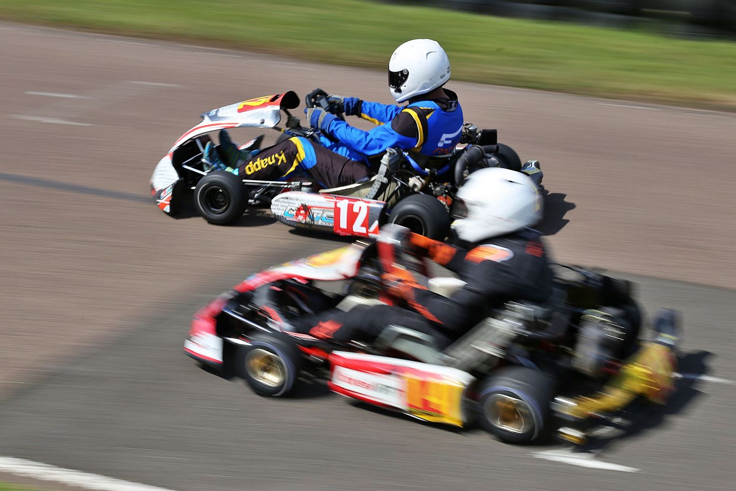 Two go-kart racers competing on a track.