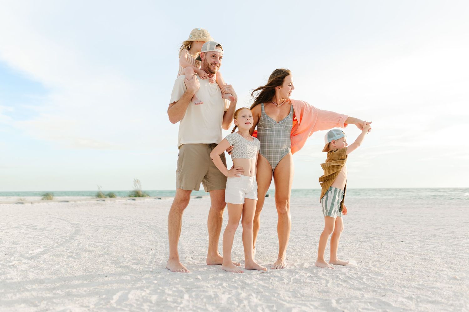 Candid family portrait on the beach in South Florida by Erika Adams Photography, fun playful photos at the beach.