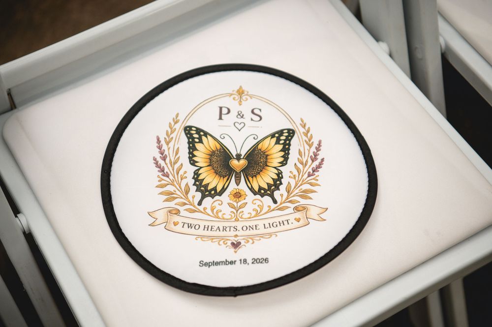Custom wedding logo coaster with butterfly design, initials P&S, and date September 18, 2026.