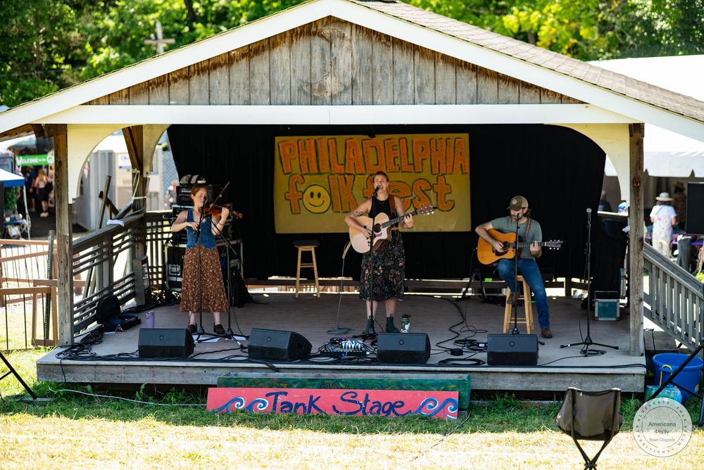Band performing on the Junk Stage at Minglewood Fest outdoor music festival on a sunny day.