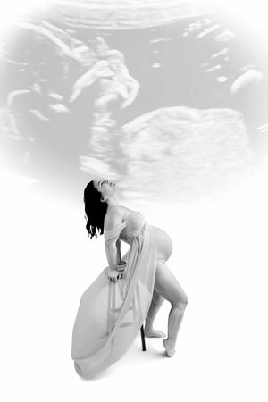 Black and white maternity photo of pregnant woman with ultrasound image overlay, artistic double exposure portrait.
