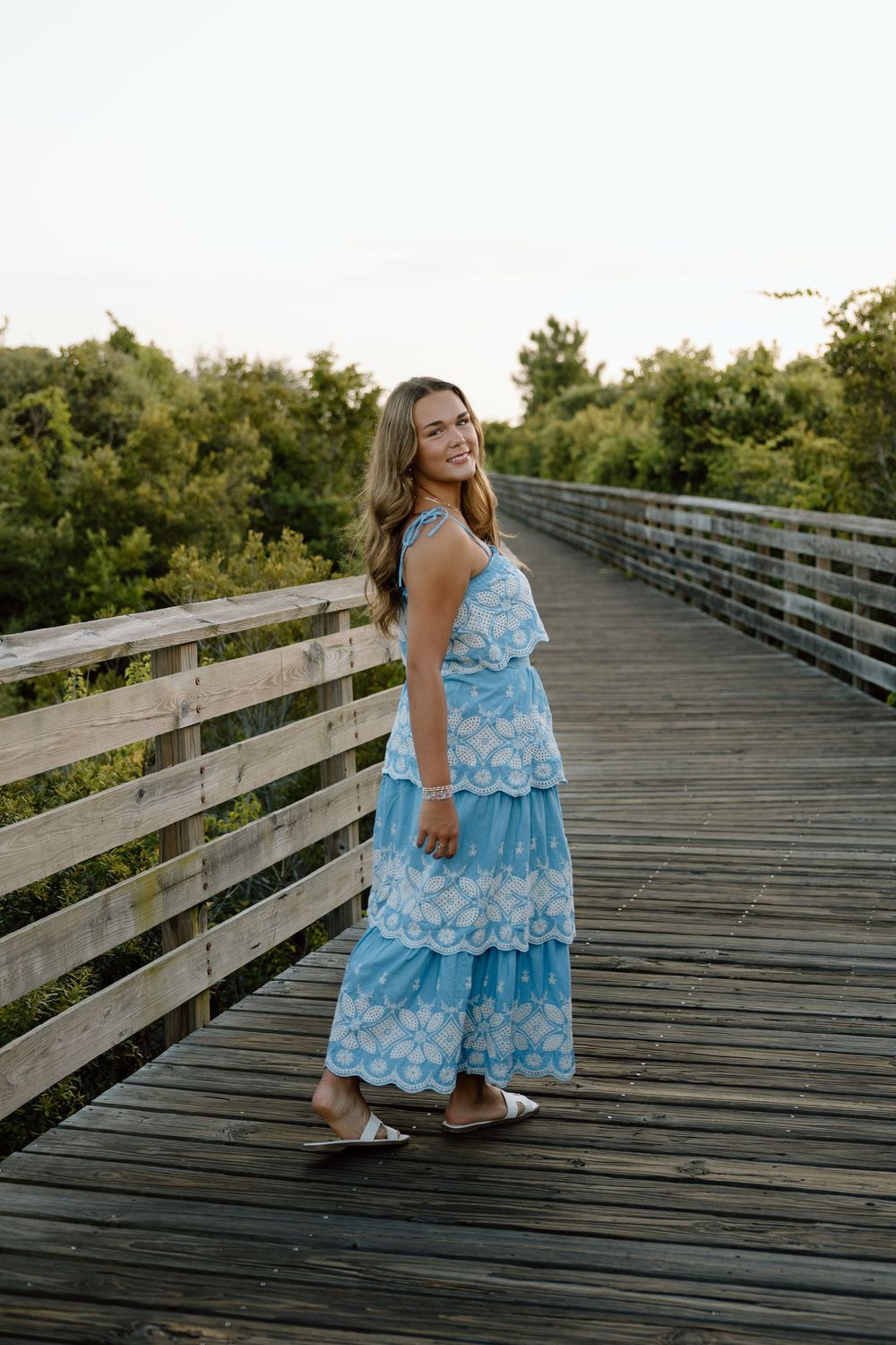 Senior portraits session at the beach in the sand on the boardwalk in gulf shores and orange beach alabama.