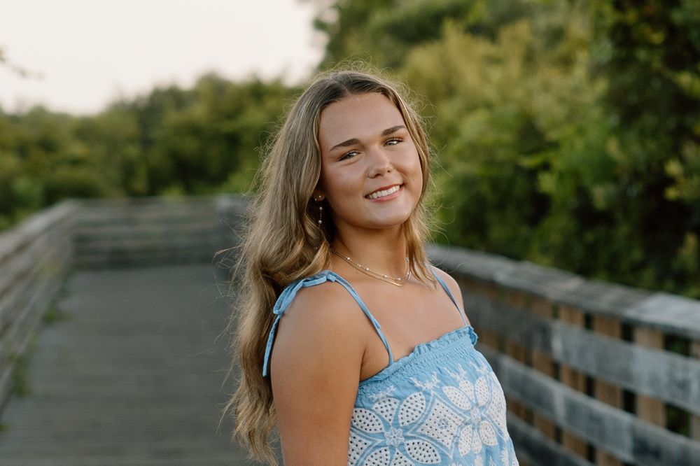Senior portraits session at the beach in the sand on the boardwalk in gulf shores and orange beach alabama.