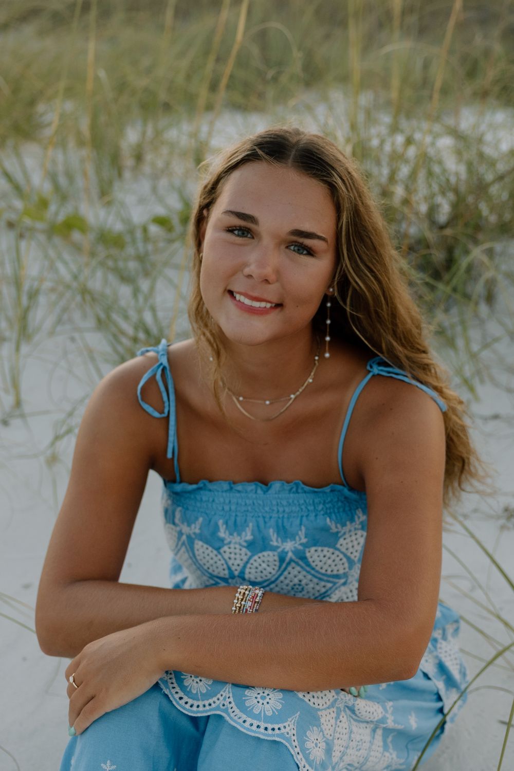 Senior portraits session at the beach in the sand on the boardwalk in gulf shores and orange beach alabama.