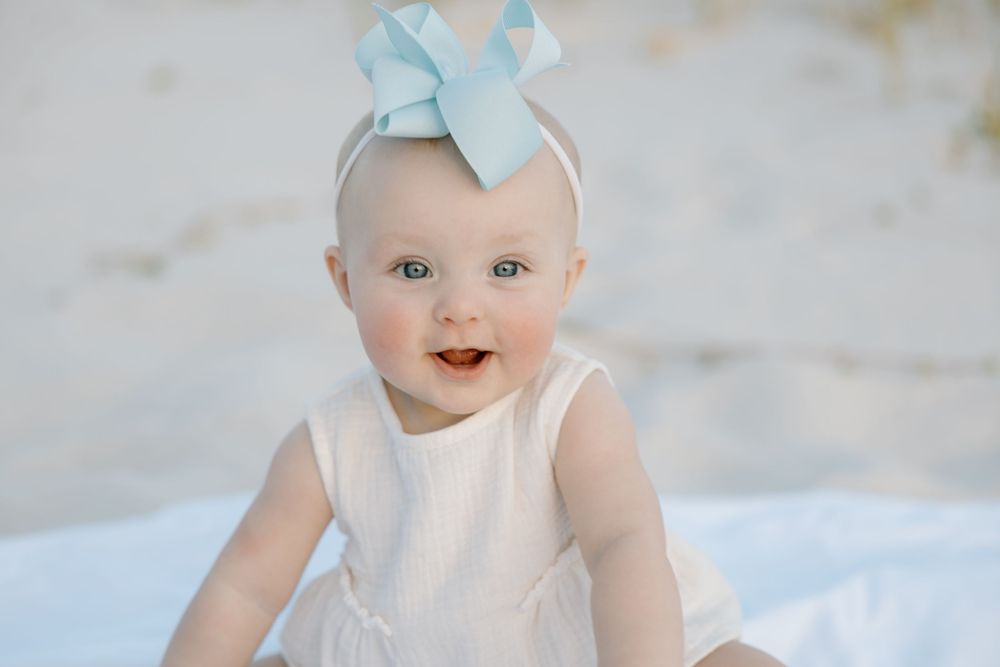 Baby walking on the sand at the beach in Alabama Orange beach and Gulf Shores.