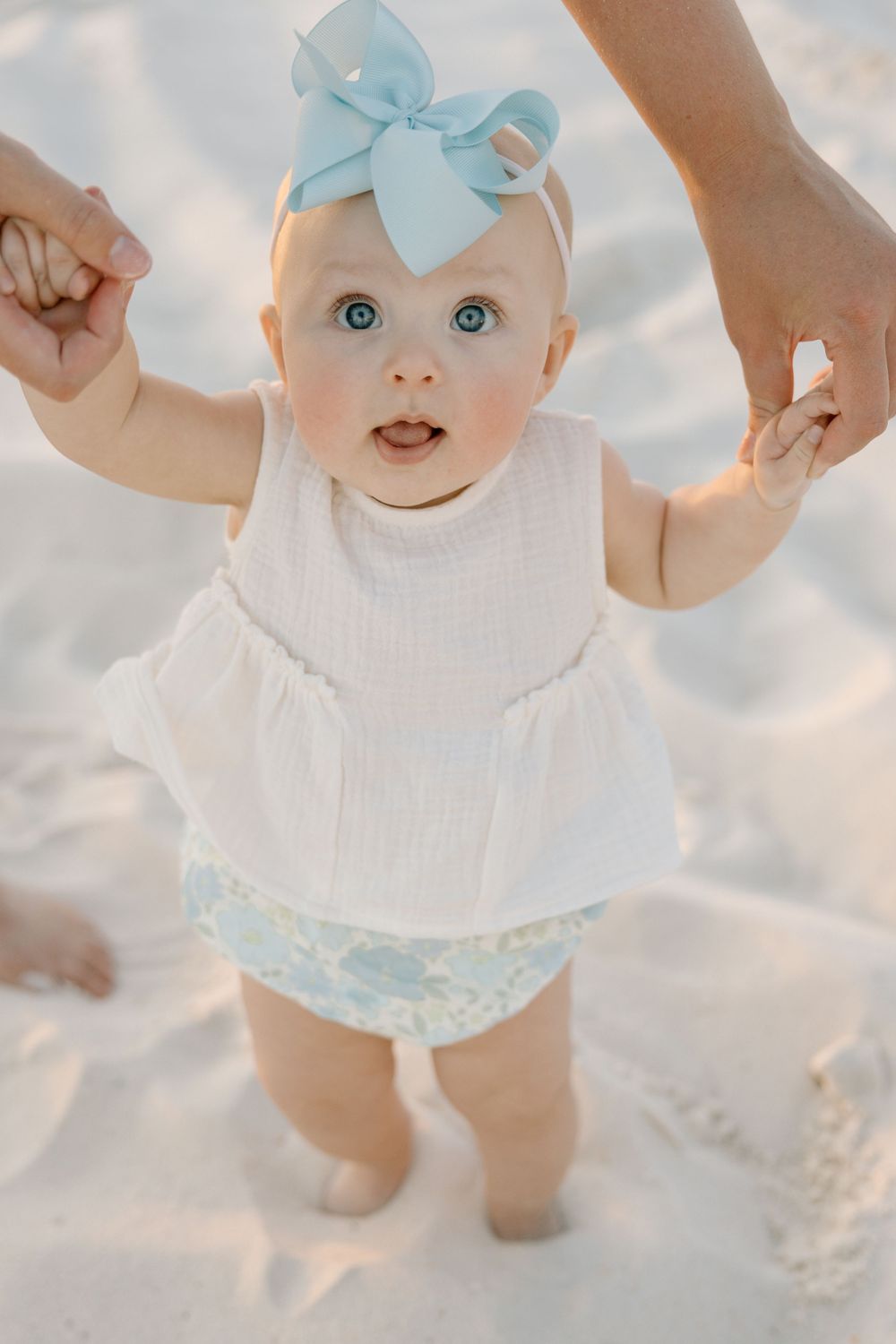 Baby walking on the sand at the beach in Alabama Orange beach and Gulf Shores.