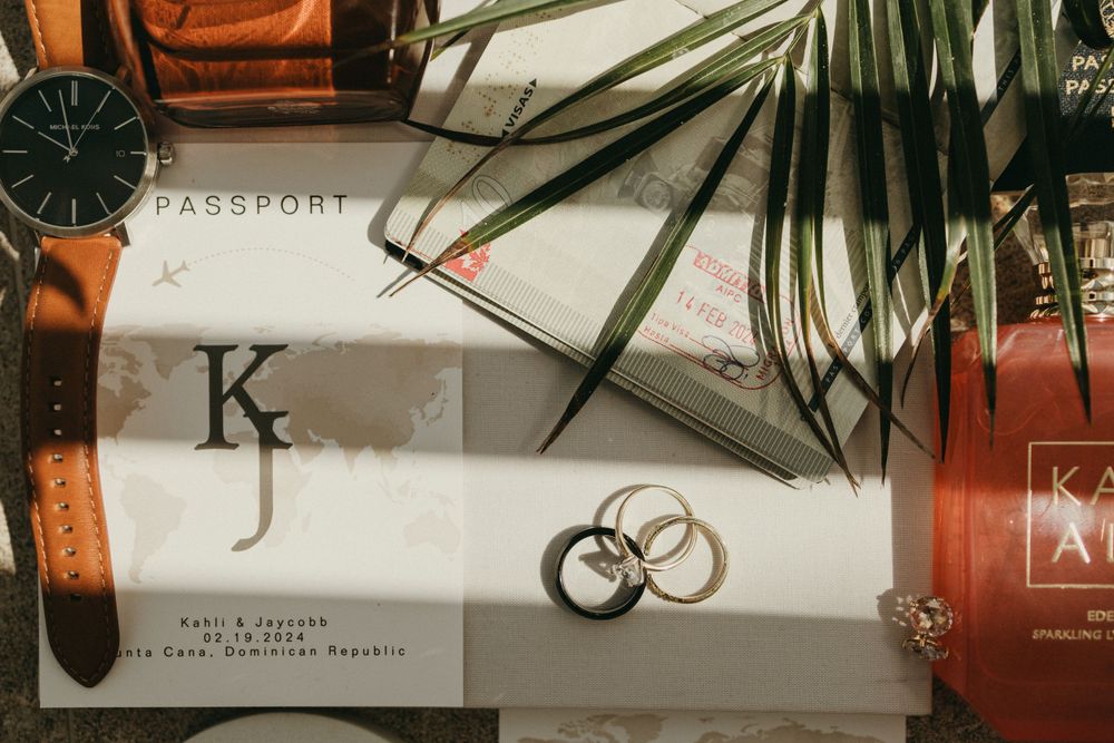 Minimalist desk setup with palm leaves and modern accessories in neutral tones.
