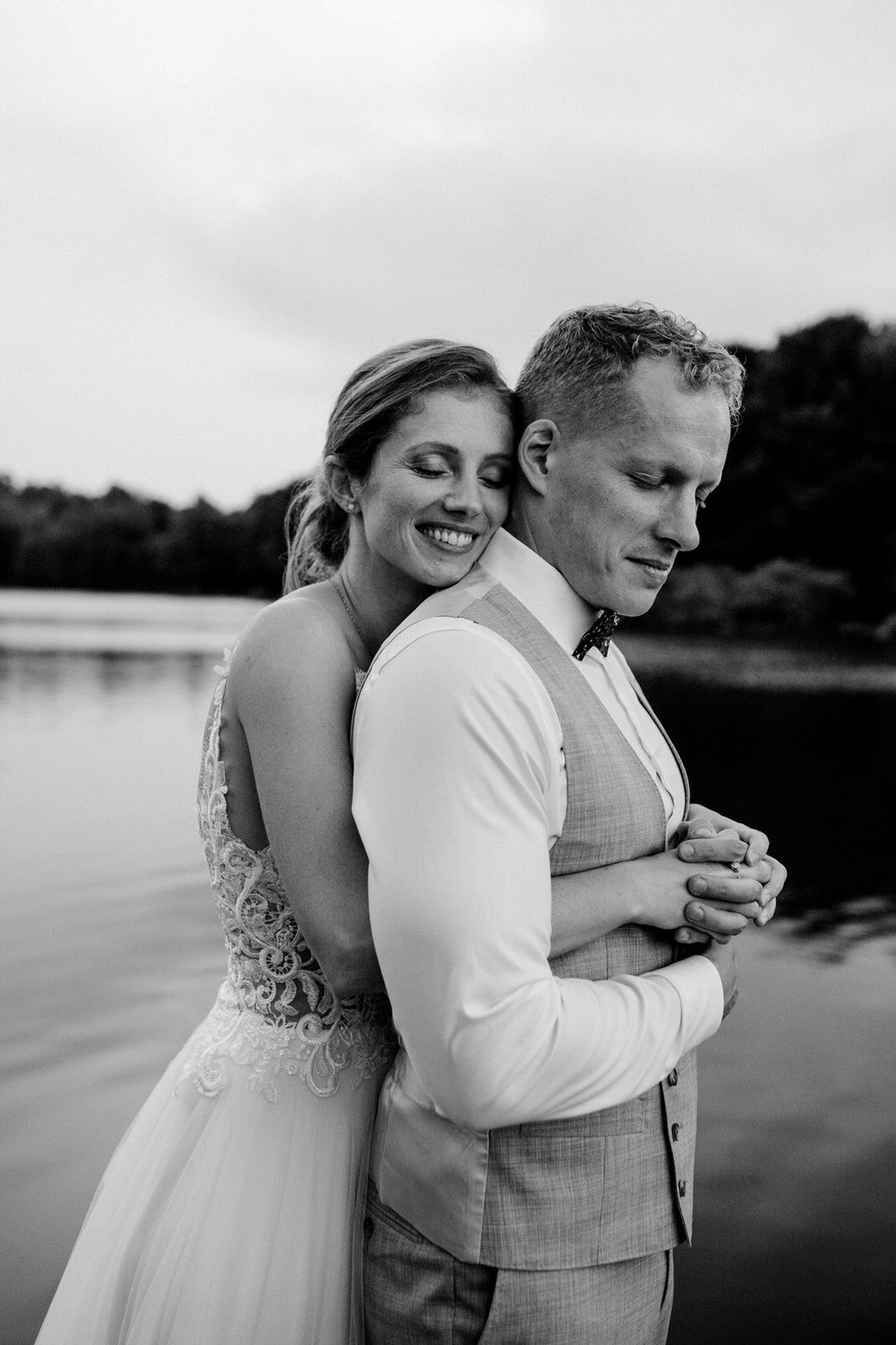 Intimate black and white portrait of a couple sharing a tender moment by the lake.Weiherhof Wächtersbach