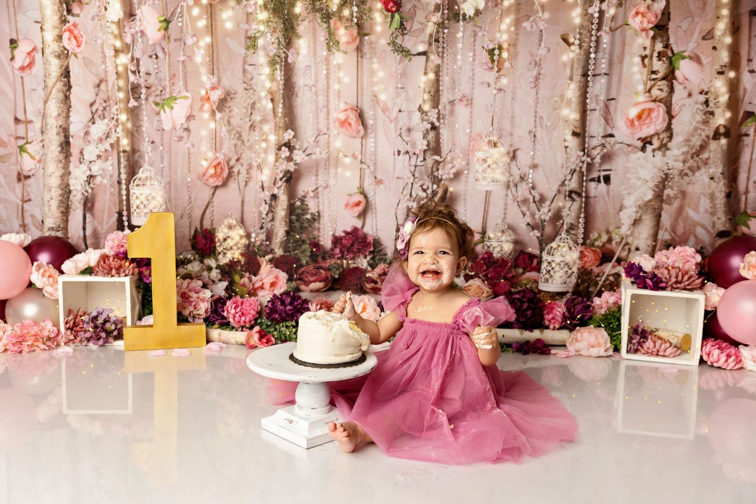 One year cake smash session with pink floral backdrop baby girl milestone New Hampshire