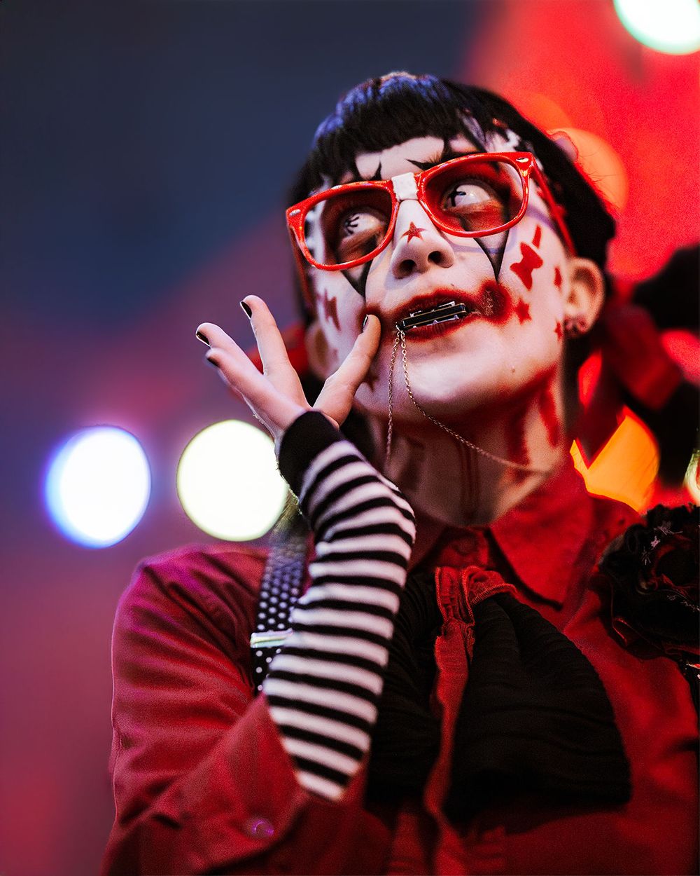 Knott’s Scary Farm monster portrait featuring a female clown holding a harmonica at the Halloween event in Buena Park, Ca