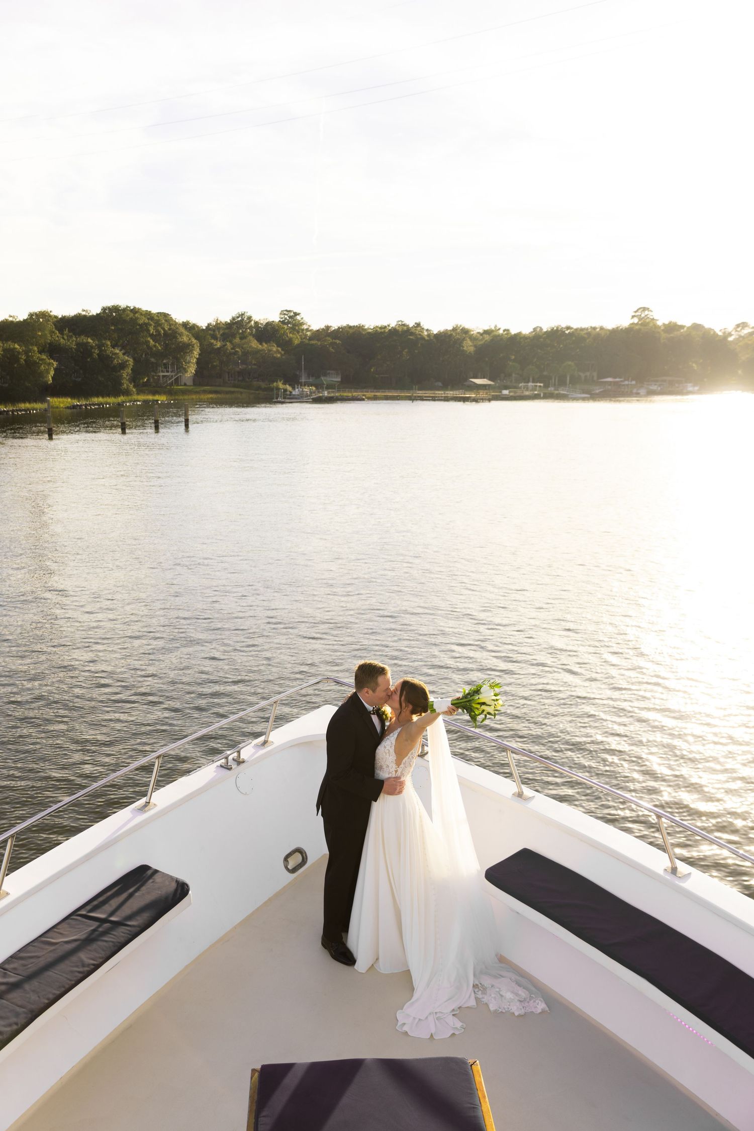 Wedding portraits in a tropical garden setting with palm trees and natural sunlight.