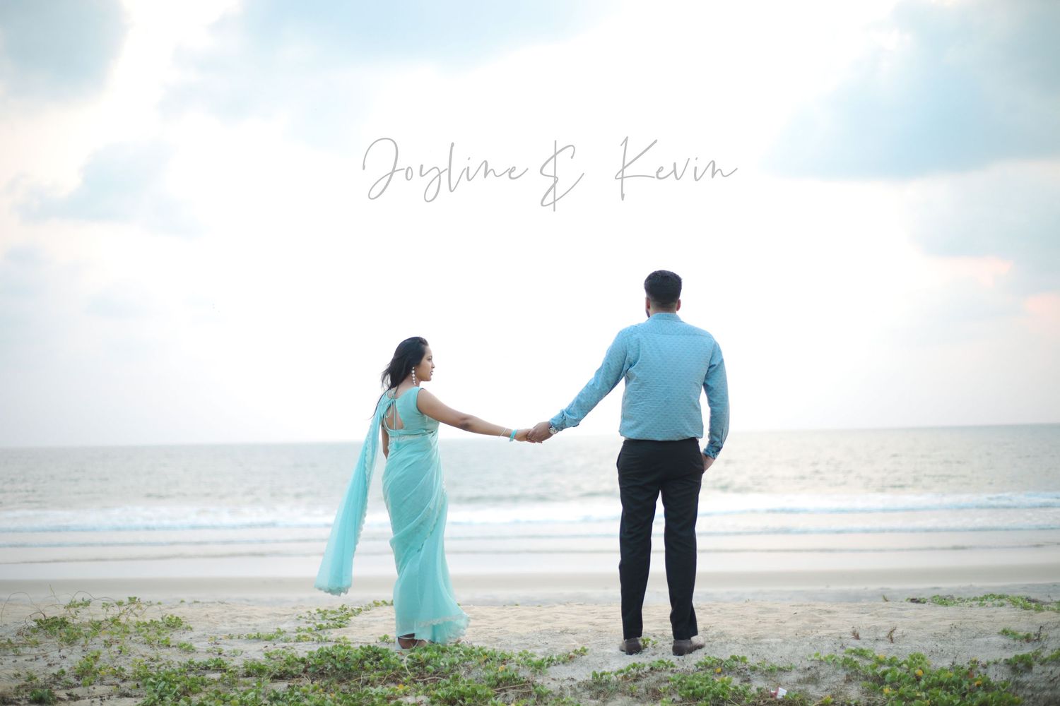 Couple holding hands and walking together along a beach