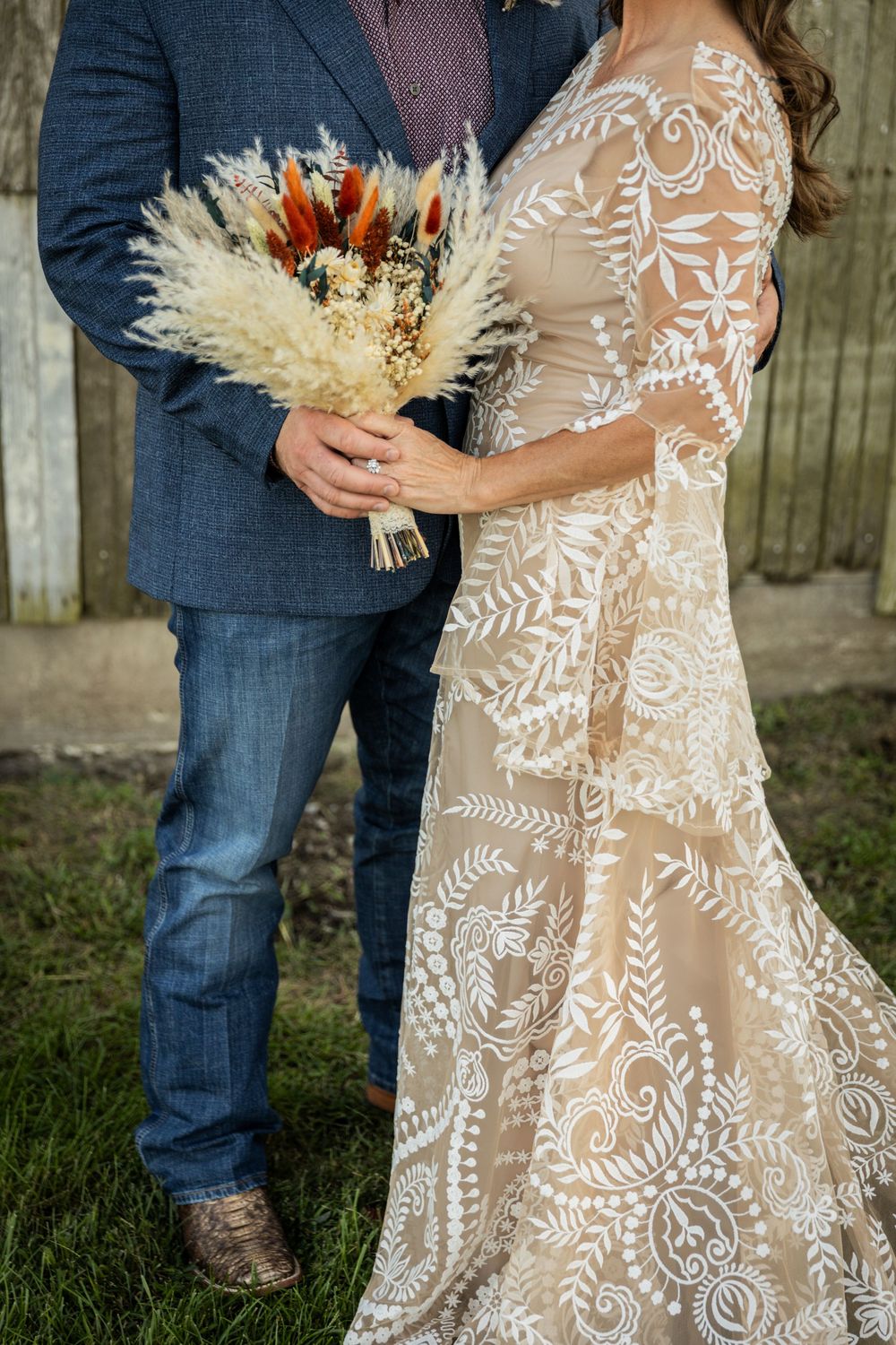 Intricate lace wedding dress with delicate floral patterns and flowing train.