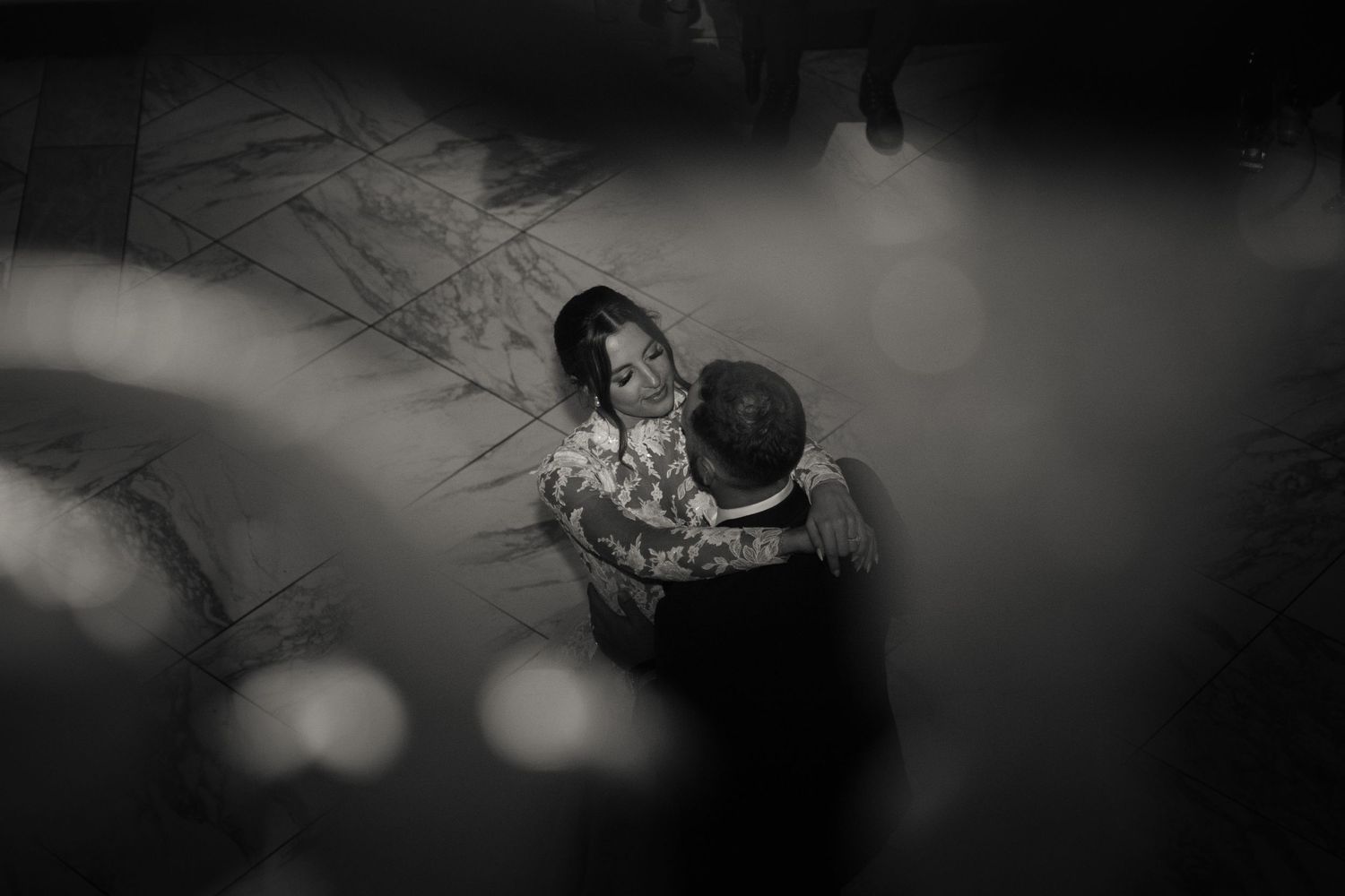 Intimate shot of a couple during their first dance in black and white
