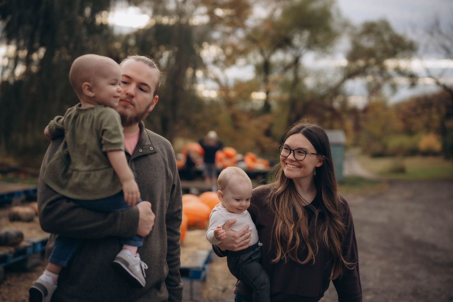 Autumn outdoor photoshoot with pumpkins and natural lighting.