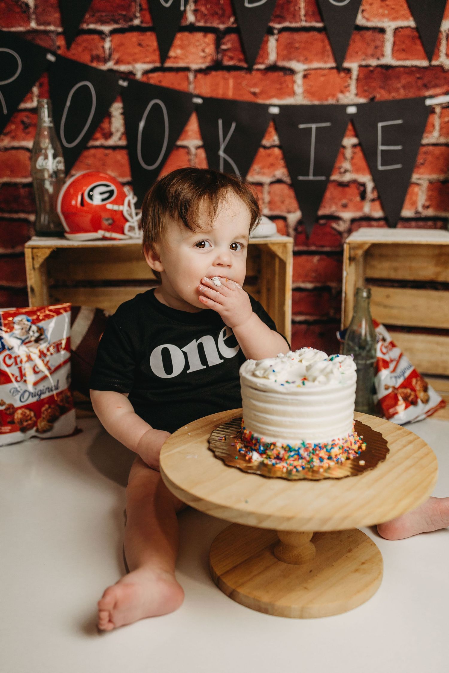 One year old birthday setup with cake and Georgia Bulldogs theme decor.