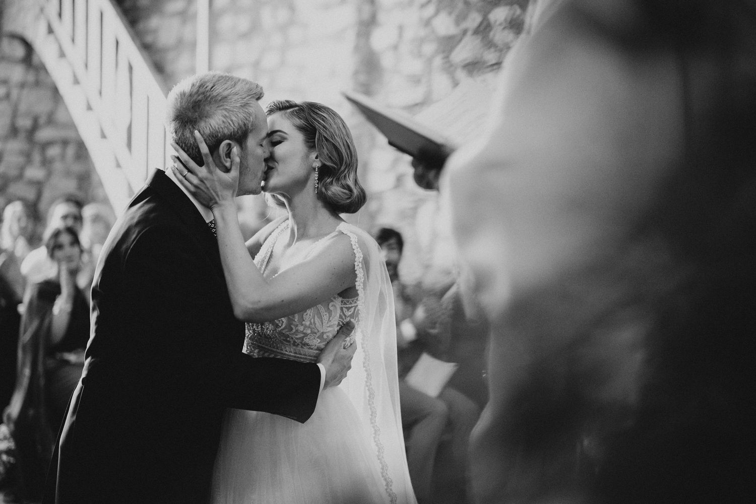 Joyful wedding celebration with confetti shower as couple exits ceremony.