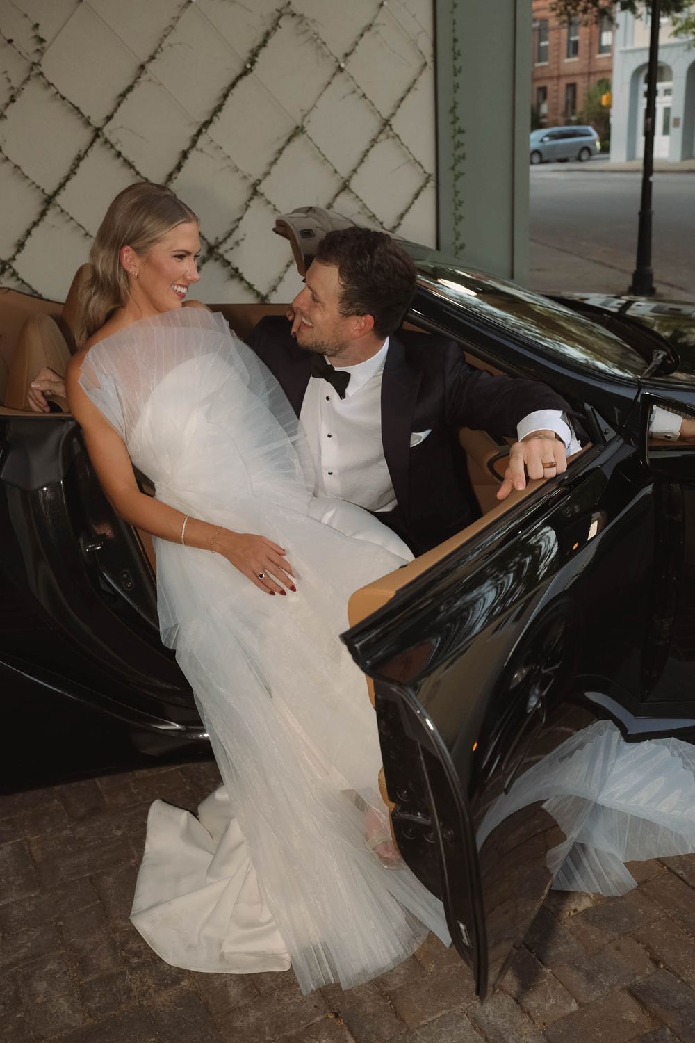 Elegant vintage wedding car ready for newlyweds to drive off after the ceremony